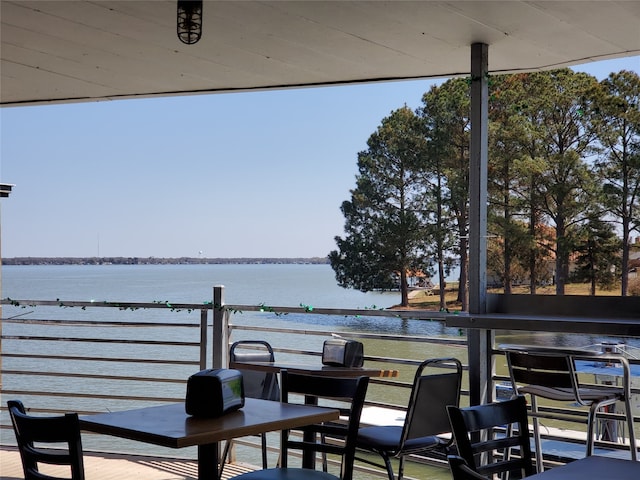 exterior space with a balcony and a water view