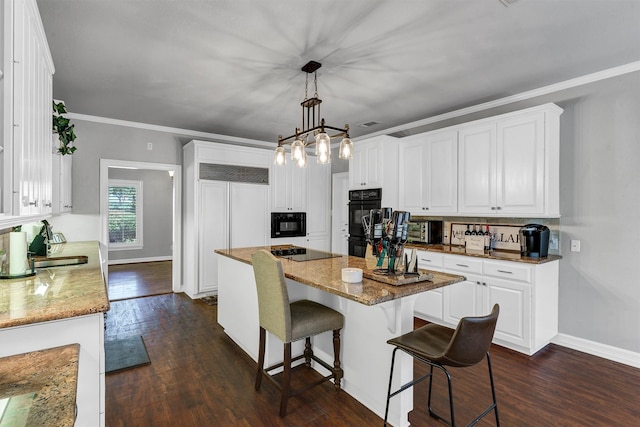 kitchen with white cabinets, dark hardwood / wood-style floors, hanging light fixtures, and a kitchen island