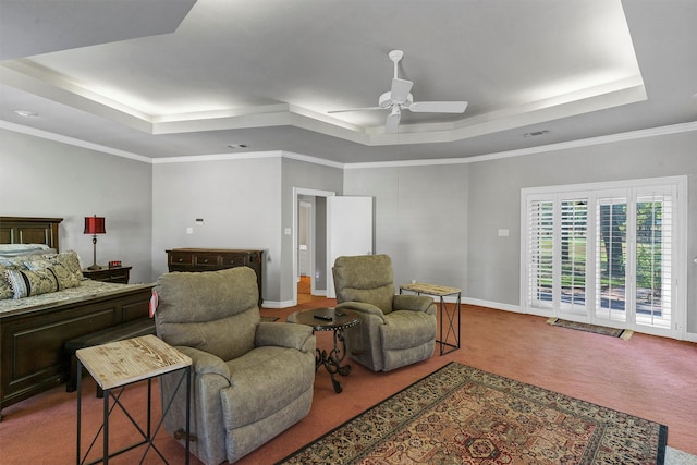 carpeted bedroom featuring ceiling fan, access to exterior, a tray ceiling, and ornamental molding