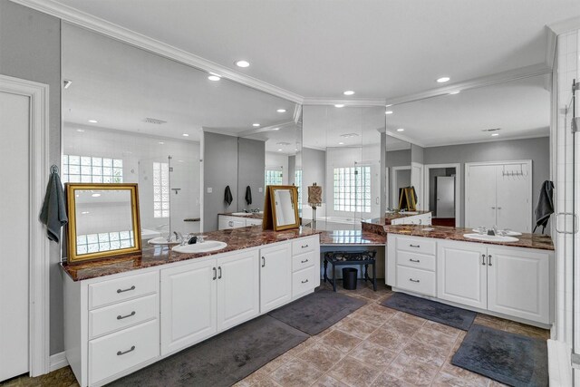 bathroom with tile patterned flooring, vanity, and crown molding