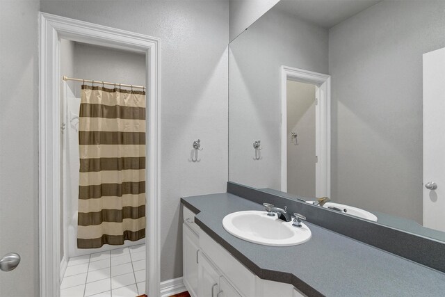 bathroom featuring tile patterned flooring, vanity, and a shower with curtain