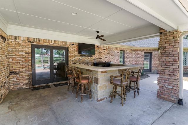 view of patio / terrace featuring a bar and ceiling fan