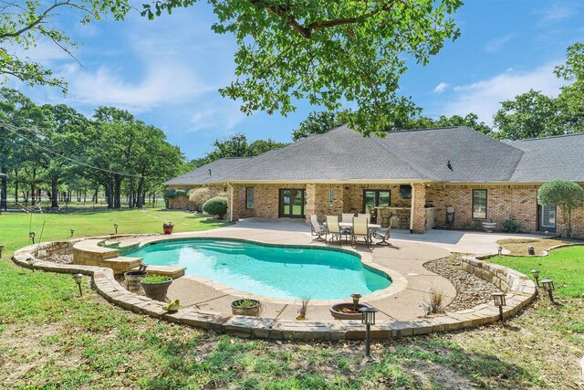 view of pool featuring a lawn and a patio area