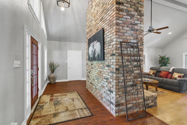 foyer with beam ceiling, dark hardwood / wood-style floors, ceiling fan, and high vaulted ceiling