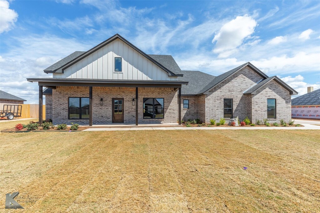 227 Ridge Rd, Tuscola, TX 79562 - modern farmhouse style home with board and batten siding, brick siding, and a front yard