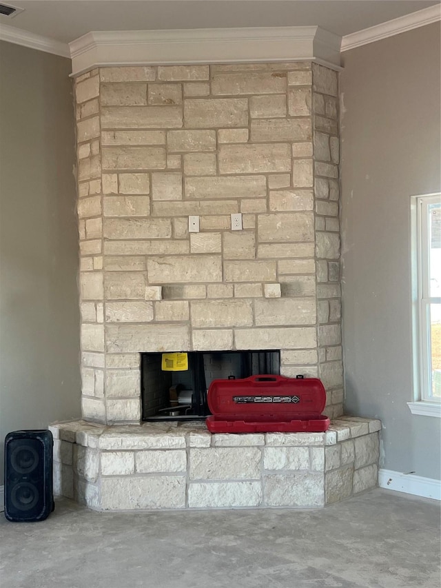 interior details featuring crown molding, a fireplace, and concrete flooring