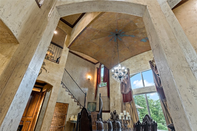 interior space featuring a towering ceiling and a notable chandelier