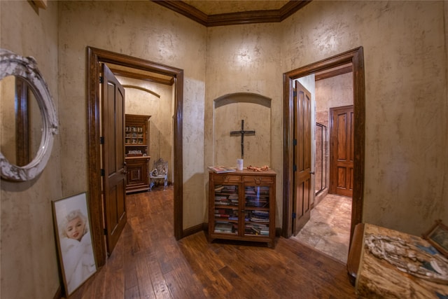 hall featuring ornamental molding and dark wood-type flooring