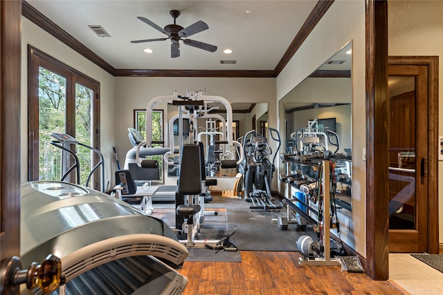 gym with hardwood / wood-style flooring, crown molding, and ceiling fan