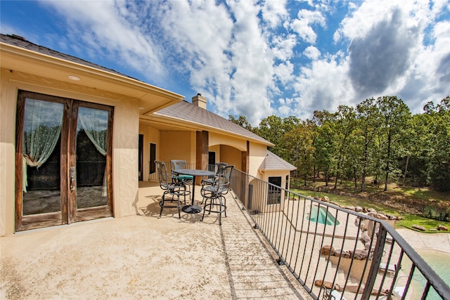 view of patio featuring a balcony