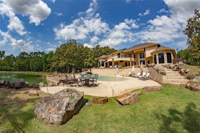 exterior space with a water view, a yard, and a patio area