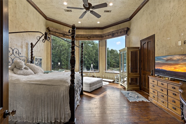 bedroom featuring dark wood-type flooring, ornamental molding, and ceiling fan