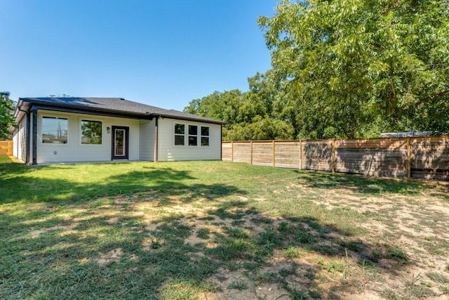 rear view of house with a lawn