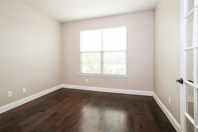 unfurnished room featuring dark hardwood / wood-style flooring