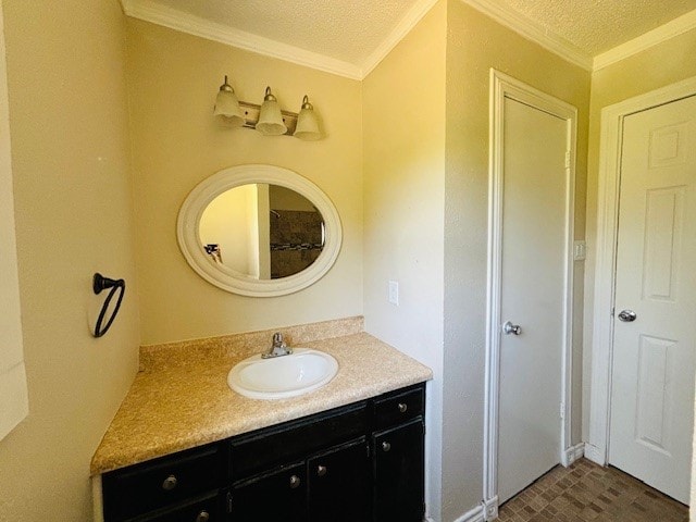 bathroom with ornamental molding, a textured ceiling, and vanity