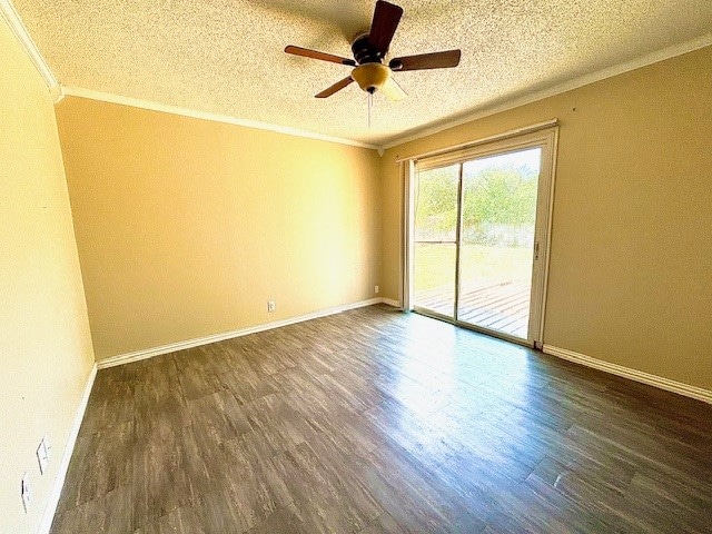 empty room with a textured ceiling, ornamental molding, dark wood-type flooring, and ceiling fan