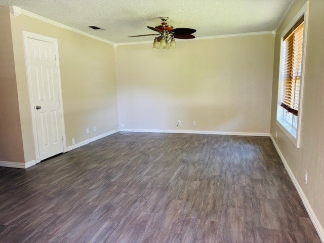 spare room featuring ceiling fan, a textured ceiling, plenty of natural light, and dark hardwood / wood-style flooring