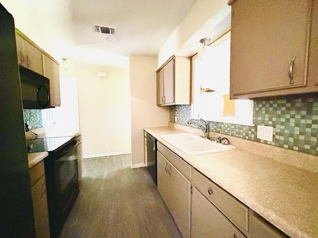 kitchen with black appliances, backsplash, and sink