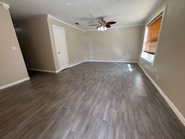 empty room with baseboards, dark wood-style floors, ceiling fan, crown molding, and a textured ceiling