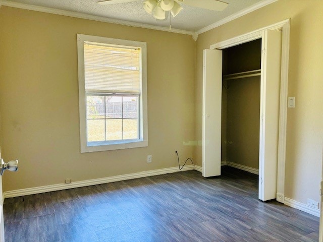 unfurnished bedroom featuring a closet, a textured ceiling, crown molding, ceiling fan, and dark hardwood / wood-style floors