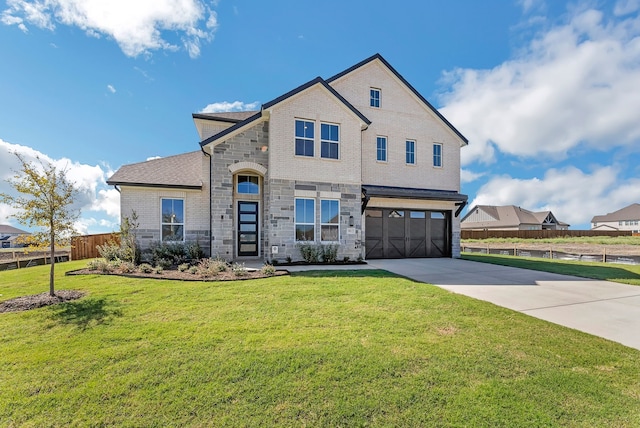 view of front of home with a front yard and a garage