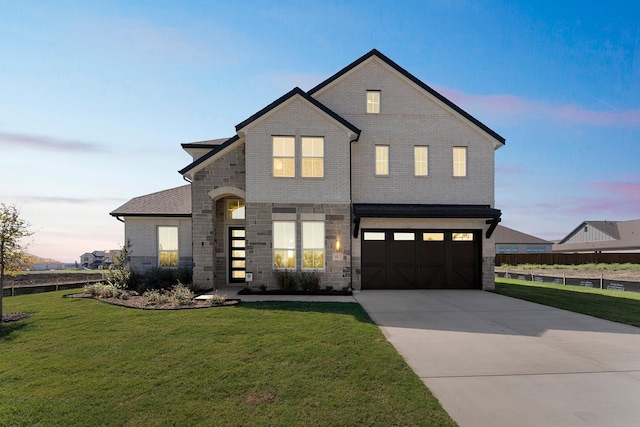 view of front facade with brick siding, concrete driveway, a garage, stone siding, and a front lawn