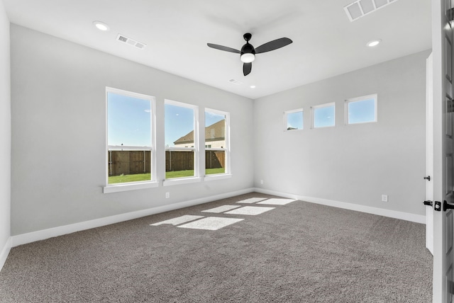 carpeted spare room with ceiling fan