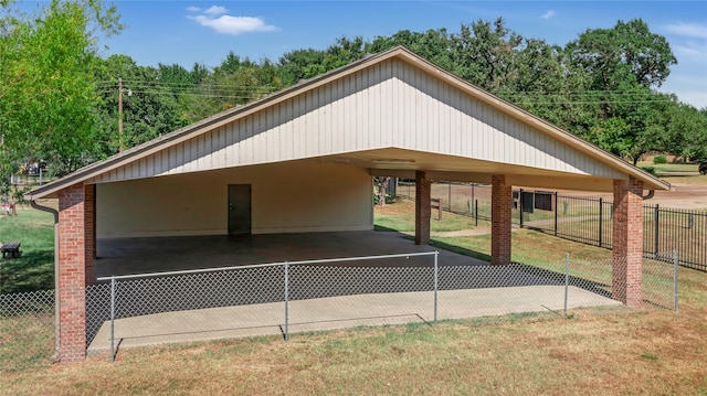 view of parking / parking lot with a yard and a carport