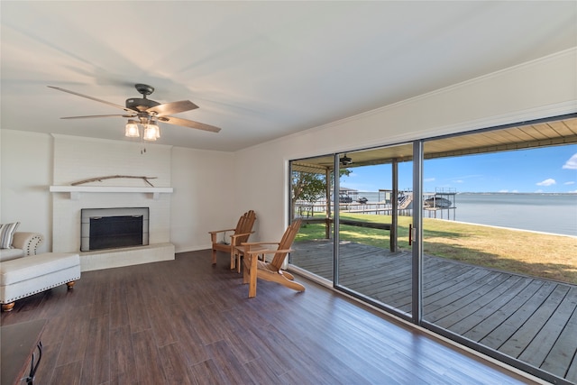 wooden terrace featuring a lawn and a water view