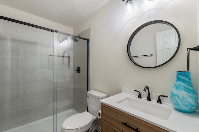 bathroom with vanity, toilet, and an enclosed shower