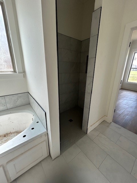 bathroom with separate shower and tub