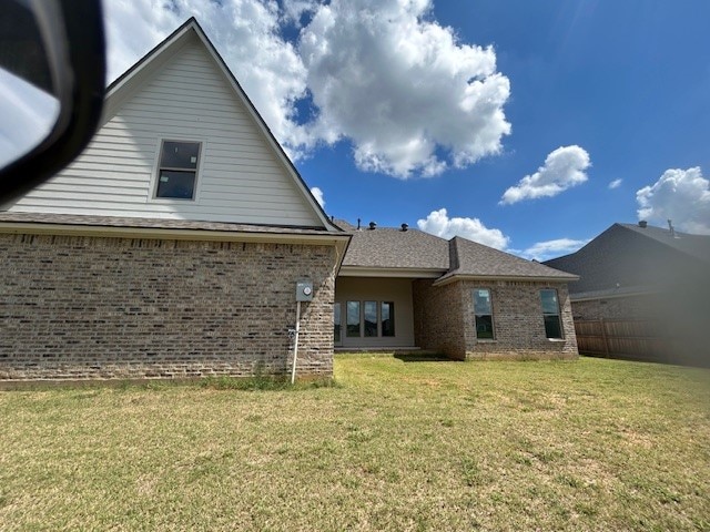 back of house with a lawn