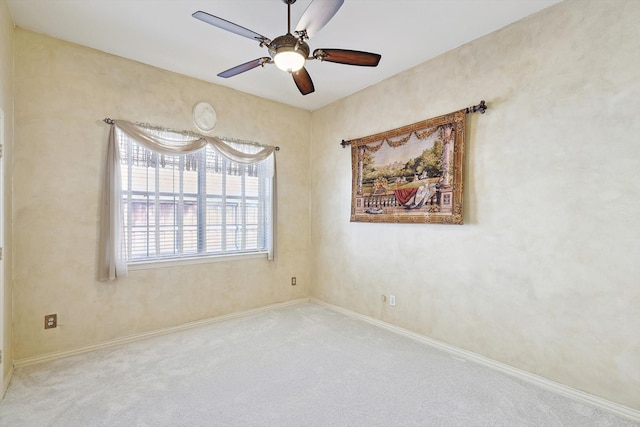 empty room with ceiling fan and carpet floors