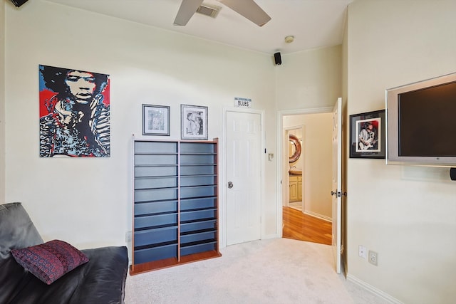 sitting room featuring carpet flooring and ceiling fan