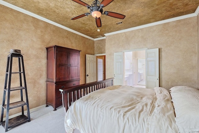 bedroom with ceiling fan, crown molding, and ensuite bathroom