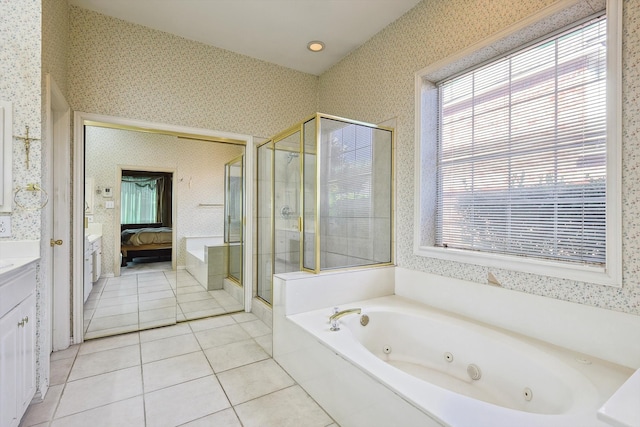 bathroom featuring tile patterned flooring, independent shower and bath, and vanity