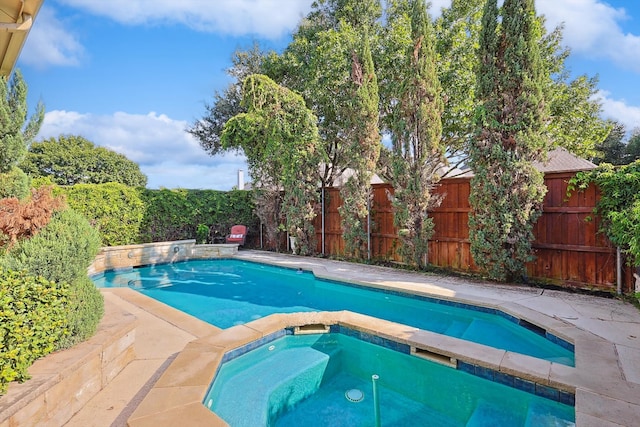 view of pool featuring an in ground hot tub