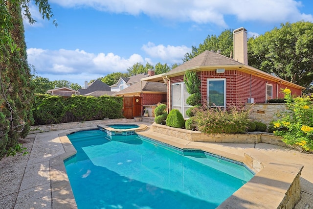 view of pool featuring an in ground hot tub