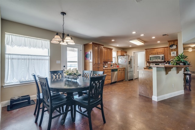 dining room with a notable chandelier and sink