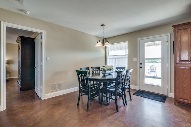 dining area featuring a notable chandelier