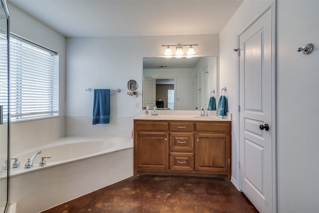 bathroom featuring concrete floors, vanity, and a bathing tub