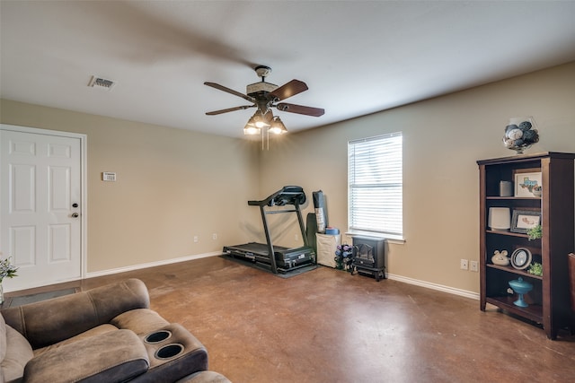 workout room featuring concrete floors and ceiling fan