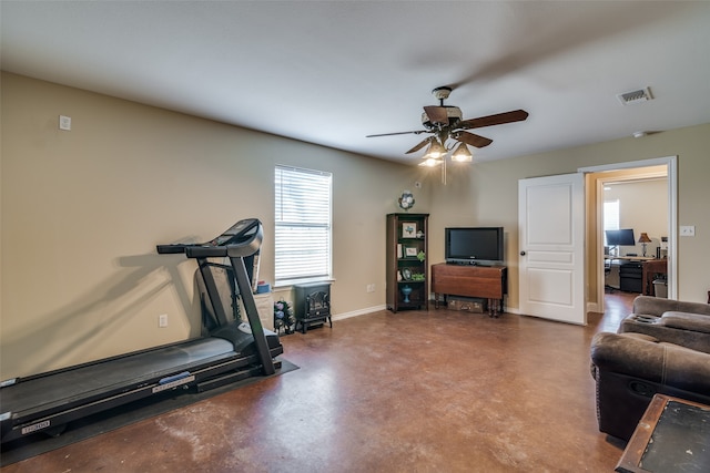 exercise area featuring concrete flooring and ceiling fan