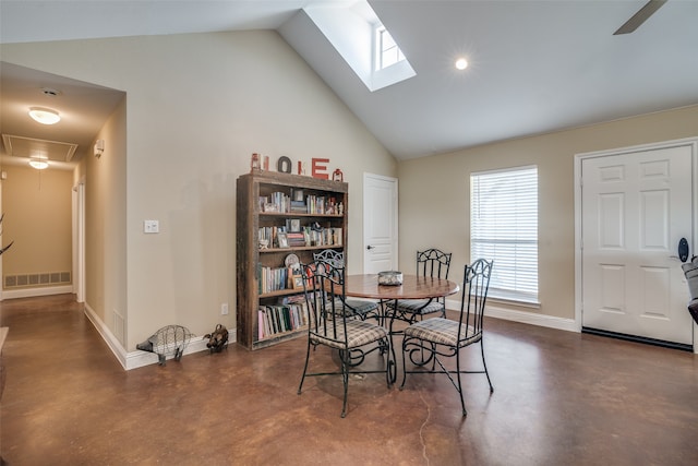 dining area featuring ceiling fan and lofted ceiling with skylight