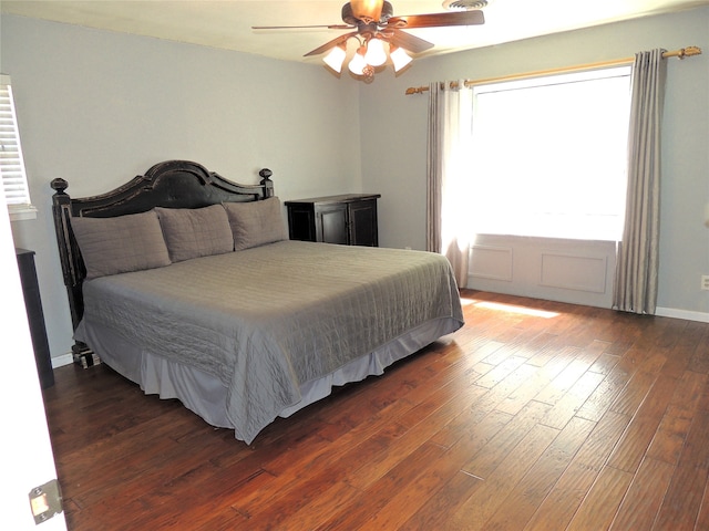 bedroom with ceiling fan and dark hardwood / wood-style floors