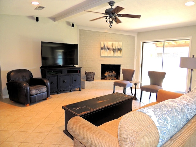 living room with ceiling fan, light tile patterned flooring, a fireplace, and lofted ceiling with beams