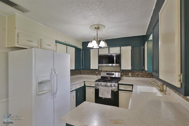 kitchen featuring hanging light fixtures, tasteful backsplash, stainless steel appliances, sink, and a chandelier