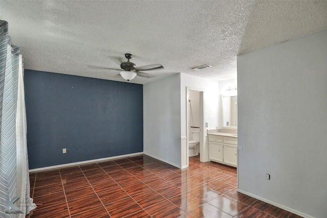 spare room with ceiling fan and a textured ceiling