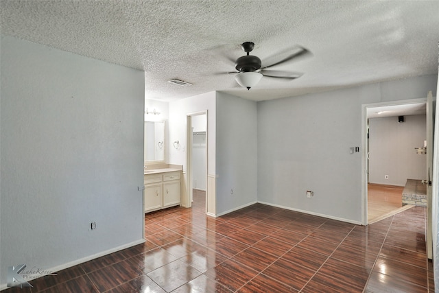 spare room with ceiling fan and a textured ceiling