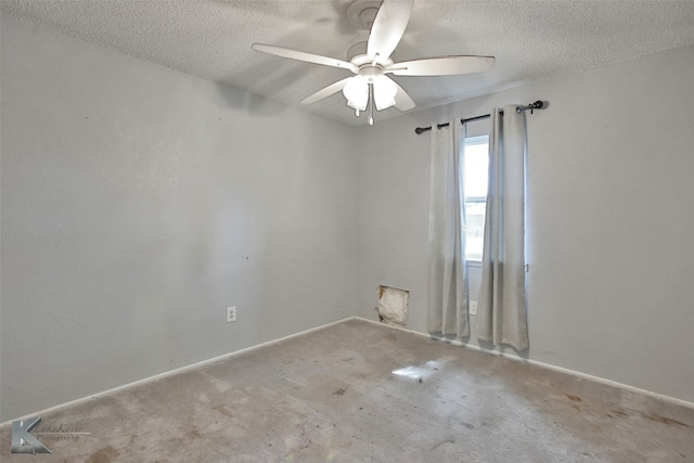 empty room with ceiling fan, carpet flooring, and a textured ceiling